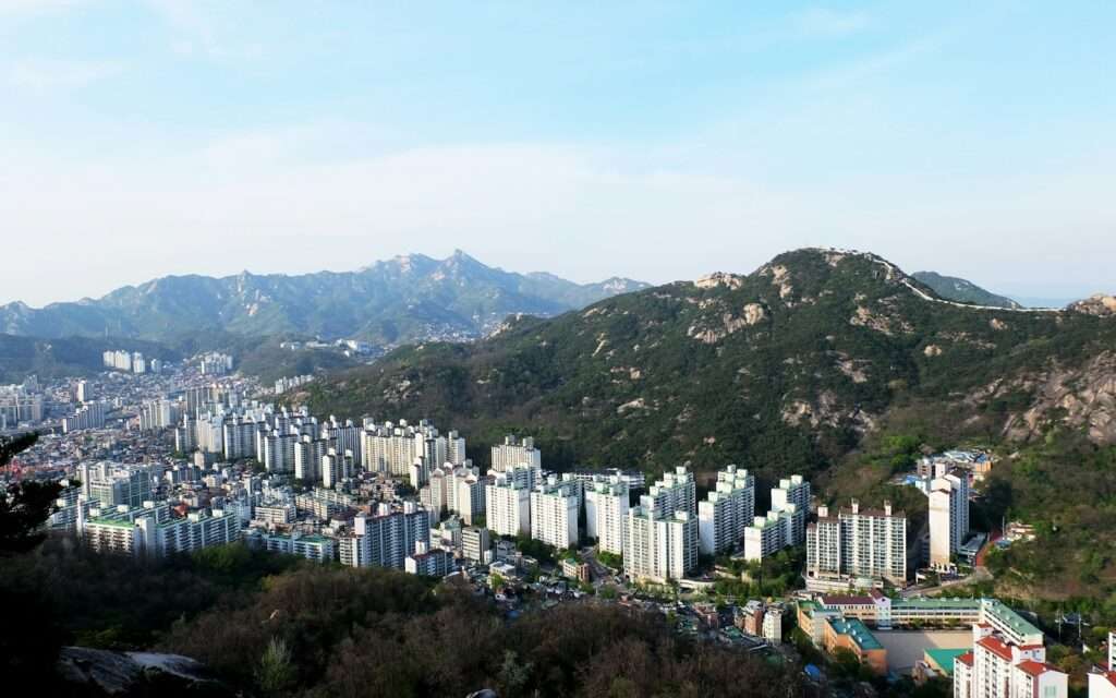 Bukhansan's granite peaks rising directly behind Seoul's apartment blocks