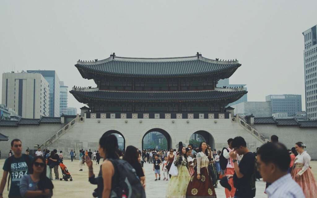 Gwanghwamun Gate at Gyeongbokgung Palace with visitors in hanbok